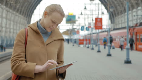 Woman-with-Tablet-on-the-Railway-Station