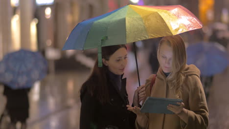 Women-talking-on-the-street-on-rainy-day