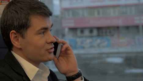 Man-having-business-call-in-the-train