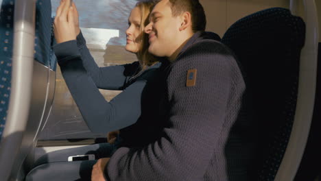 Happy-Couple-Taking-Selfie-on-Train