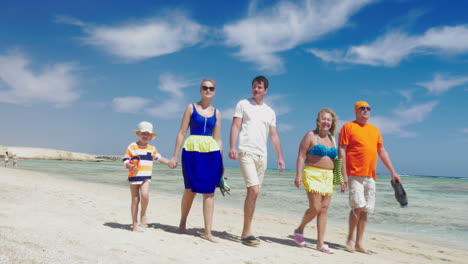 Family-having-enjoyable-walk-on-the-beach