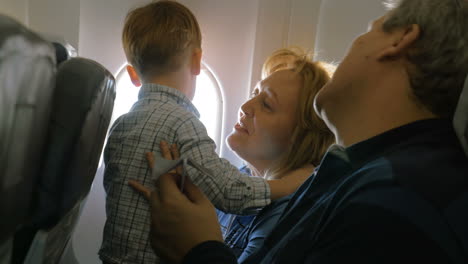 Grandparents-and-little-grandson-traveling-by-plane