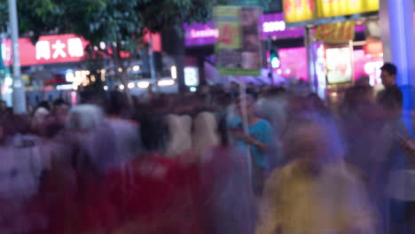 Timelapse-of-man-with-pad-in-crowded-street-at-night