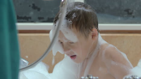 Mother-washing-foam-from-child-in-the-bath