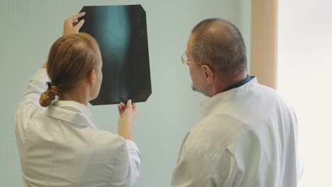 Male-and-female-doctors-examining-x-ray-images