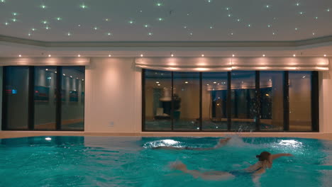 Man-and-woman-swimming-in-the-indoor-pool
