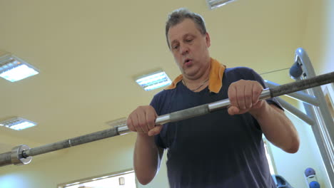 Man-exercising-with-crossbar-in-the-gym