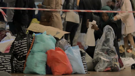 Syrian-Refugee-Choosing-Children-Clothes-at-Charity-Collecting-Point-in-Copenhagen-Railroad-Station