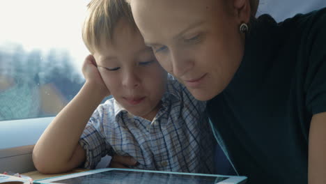 Boy-and-His-Mother-Watching-Cartooins-in-Tablet
