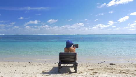 Woman-with-pad-sun-bathing-on-the-coast-of-blue-lagoon