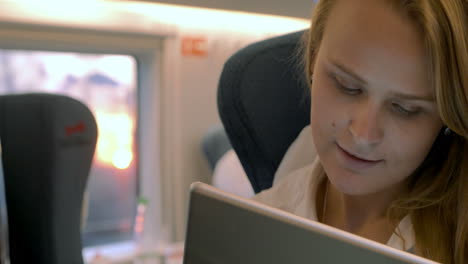 Businesswoman-uses-electronic-tablet-in-the-train
