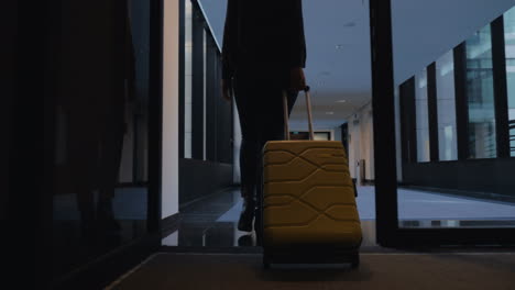 Woman-with-travel-bag-walking-to-her-hotel-room