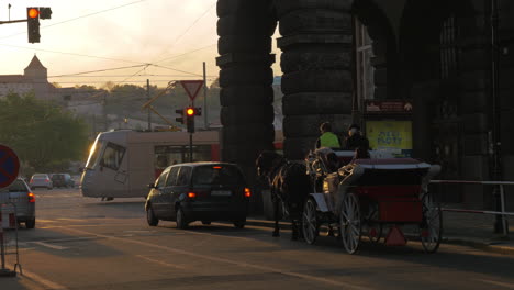 View-of-road-intersection-with-red-traffic-light-cars-horse-carriage-and-tram