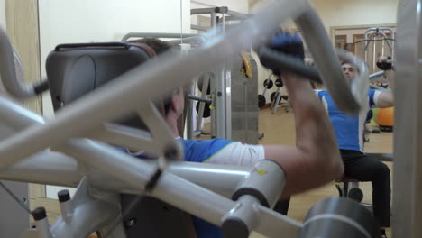 Man-having-workout-on-modern-exercise-machine
