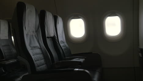 Seen-interior-decor-of-plane---black-leather-chairs-and-two-portholes
