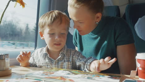 Mother-and-son-with-childrens-book-in-the-train