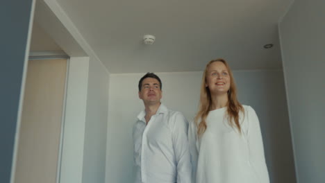 Young-couple-getting-excited-with-new-apartment