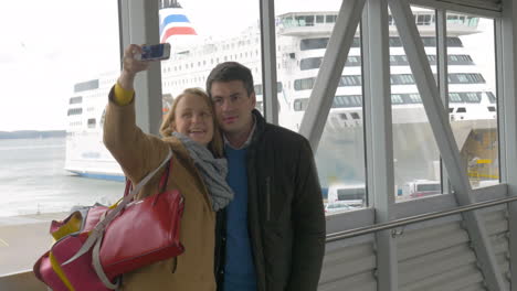 Happy-couple-making-selfie-with-phone-in-harbor