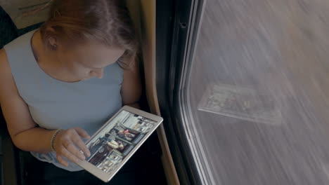 Woman-Using-Her-Tablet-In-The-Train