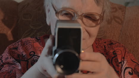 Senior-woman-filming-with-retro-video-camera