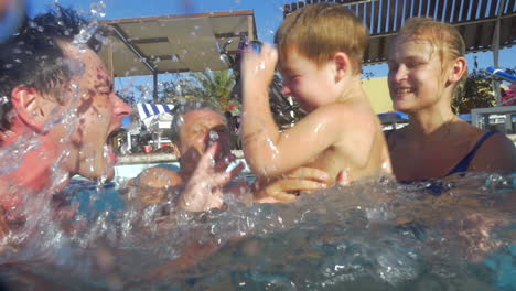 Boy-and-his-family-having-fun-in-the-pool