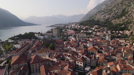Stunning-flyover-aerial-of-city-of-Kotor-in-Montenegro-flying-above-rooftops
