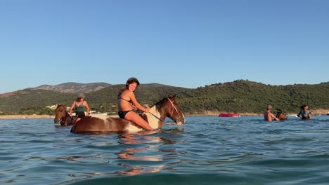 freedom-and-tranquility-for-riders-as-they-immerse-themselves-in-the-beauty-of-the-sea,-enjoying-a-bareback-horseback-ride