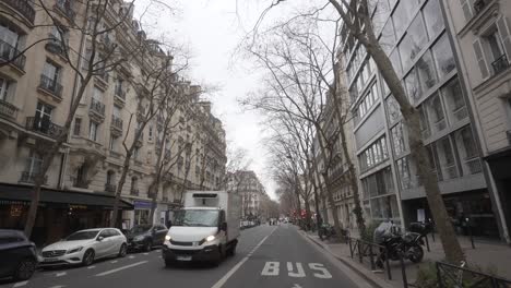 Street-with-bike-lane-and-a-truck-crossing-in-paris,-france