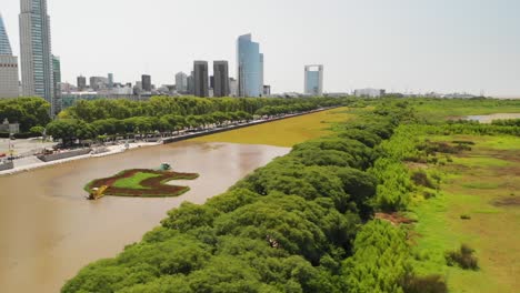 Moving-aerial-view-of-the-Buenos-Aires-Reserve-wetland-with-the-city-on-the-horizon