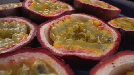 Juicy-rotating-passion-fruits-close-up,-tropical-maracuya,-tasty-exotic-fruit,-4K-macro-shot