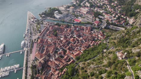 Aerial-view-down-the-mountain-of-the-old-town-Kotor-in-Montenegro,-cityscape