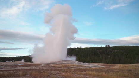 Cinematic-famous-Old-Faithful-geyser-sunrise-sunset-eruption-Yellowstone-National-Park-observation-deck-viewing-area-Upper-Geyser-Basin-active-volcano-fall-autumn-October-pink-orange-slow-motion
