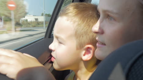 Mother-and-son-looking-out-car-window
