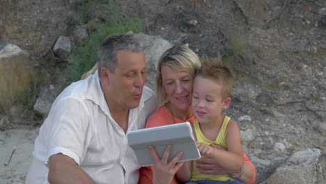 Grandparents-and-grandchild-with-pad-outdoor