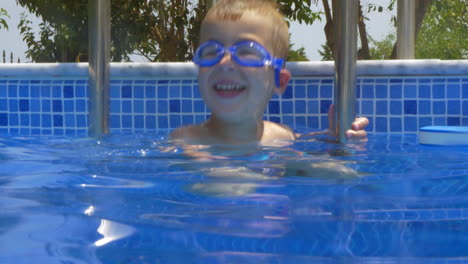 Smiling-Boy-in-Goggles-in-Swimming-Pool