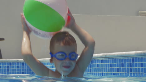 Little-playful-child-with-ball-in-pool