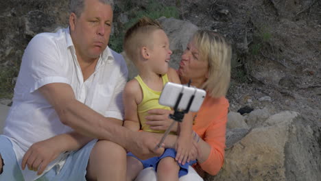 Grandparents-and-grandchild-making-funny-mobile-selfie
