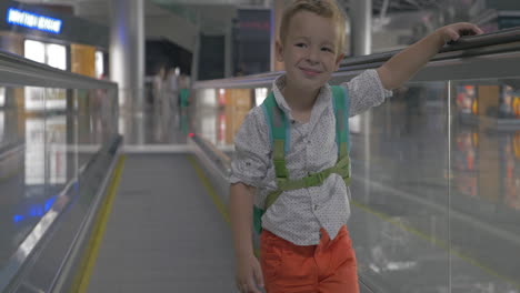 Cute-little-boy-on-travelator-in-airport