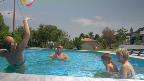 United-Family-Playing-Inflatable-Ball-in-Home-Pool