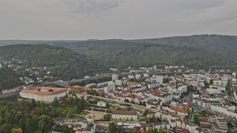 Decin-Czechia-Aerial-v3-drone-flyover-Park-Na-Marianske-Louce-capturing-landmark-castle-by-the-riverbank-of-Elbe-river,-downtown-cityscape-and-hillside-views---Shot-with-Mavic-3-Cine---November-2022