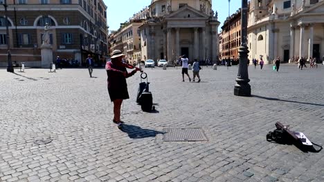 Woman-tosses-money-to-a-street-musician-in-Piazza-del-Popolo-in-Rome,-Italy