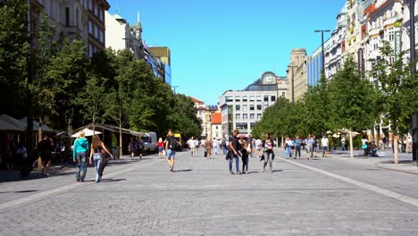 Panoramic-view-of-Wenceslas-Square-in-the-center-of-Prague,-sunny-day-on-a-cobblestone-walkway,-Czech-Republic