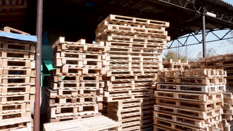 Warehouse-with-stacked-wooden-pallets-ready-for-distribution