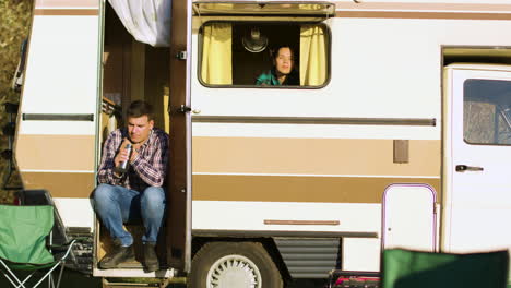 Boyfriend-sitting-on-the-stairs-of-camper-van