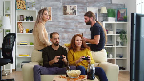 Girlfriend-with-red-hair-trying-to-beat-her-friend-while-playing-video-games