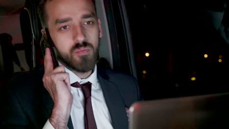 Bearded-businessman-in-business-suit-having-a-phone-call