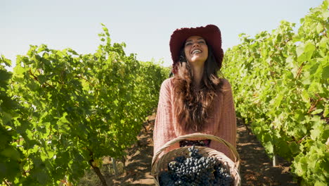 Woman-with-a-basket-of-grapes-in-hands-laughing