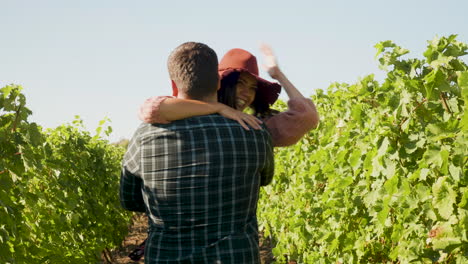 Close-up-of-man-embracing-a-woman-in-the-vineyard