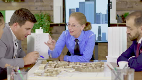 Middle-age-female-architect-in-a-meeting-with-his-team-in-the-conference-room