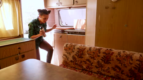 Couple-after-a-walk-in-the-mountains-entering-in-their-retro-camper-van